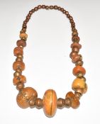 A 19thC beaded amber, bronze and copper necklace, 440g