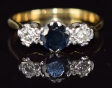 An 18ct gold ring set with a sapphire and two diamonds, 2.4g, size O