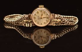 Tissot 9ct gold ladies wristwatch with gold hands and Arabic numerals and silver dial, on 9ct gold