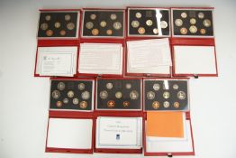 Seven Royal Mint UK proof coin sets comprising 1985-1988 and 1990-1992, in deluxe cases with
