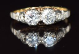 A c1940 18ct gold ring set with two round cut diamonds, each approximately 0.35ct with further