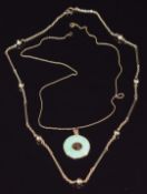 A jadeite pendant with 14k gold mounts and Chinese character to the centre, on 14k gold chain (0.8g)