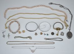 A collection of silver jewellery including two bangles, locket, necklaces, silver bracelets and a