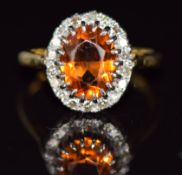 An 18ct gold ring set with an opal cut fire opal and diamonds, 3.5g, size J/K