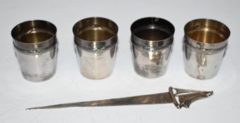 Four French silver shot measures or tumblers with gilt interiors, height 4cm, together with a