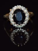 A 9ct gold ring set with a sapphire and diamonds, 3.8g, size P