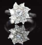 An 18ct white gold ring set with a round cut diamond of approximately 0.45ct surrounded by