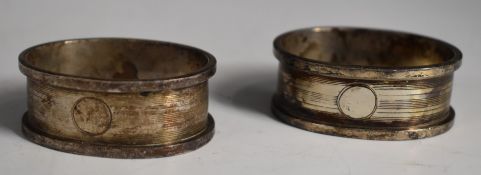 Three hallmarked silver napkin rings and two hallmarked silver spoons, weight 91g, together with a