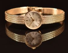 Garrard 9ct gold ladies wristwatch with gold hands and hour markers, silver dial and quartz