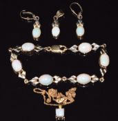 A suite of 9ct gold jewellery comprising bracelet, earrings and pendant set with opal cabochons, and