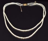 A double strand of natural pearls, largest pearl 4.4mm and smallest 2.6mm, with Gem & Pearl Lab
