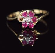 A 9ct gold ring set with a diamond and rubies in a cluster, 1.7g, size M