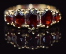 A 9ct gold ring set with five garnets, 2.5g, size L