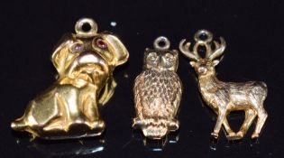 Three 9ct gold charms including dog, owl and deer, 3.5g