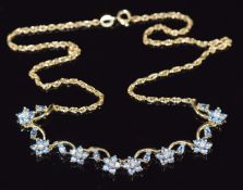 An 18ct gold necklace set with cubic zirconia and quartz in flower clusters, 40cm long, 8.8g