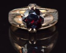 A 9ct gold ring set with a round cut garnet, 5.6g, size N