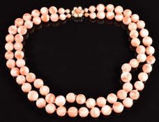 A double strand coral necklace, the 9ct gold clasp set with coral and pearls, 95.9g, 40cm long