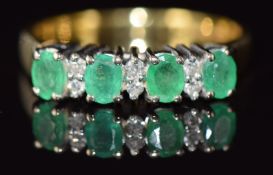 An 18ct gold ring set with alternating emeralds and diamonds, 3.4g, size M