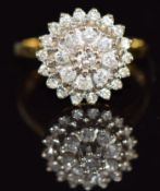 An 18ct gold ring set with diamonds in a cluster, 5.8g, size N
