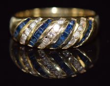 An 18ct gold ring set with square cut sapphires and round cut diamonds, 3.9g, size M