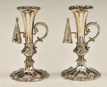 Pair of Victorian hallmarked silver chamber or candlesticks with scrolling handles and attached
