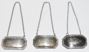 Pair of modern hallmarked silver bottle tickets for sherry and brandy together with a similar silver
