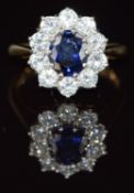An 18ct gold ring set with an oval cut sapphire of approximately 1ct surrounded by diamonds, each