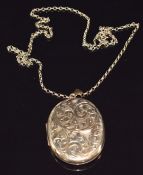 A 9ct gold locket with chased decoration on 9ct gold chain, locket 5 x 4cm, 29.9g