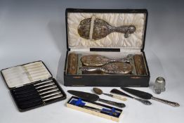 Cased hallmarked silver mounted dressing table set comprising hand mirror, comb and four brushes,