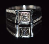An 18ct white gold ring set with a diamond of approximately 0.2ct and further diamonds to the