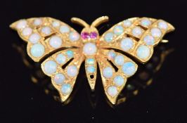 A 9ct gold butterfly brooch set with opals and ruby eyes, 5.5g, 4 x 1.8cm