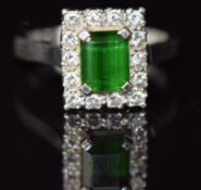 An 18ct white gold ring set with an emerald cut tourmaline surrounded by diamonds, 5.6g, size N