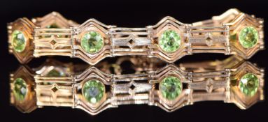 A c1915 9ct gold bracelet set with round cut peridots, 17.6g, 17cm long