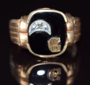 A 10k gold signet ring set with onyx and a diamond, 5.9g, size T