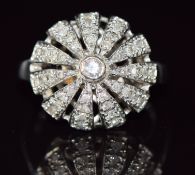 A 9ct white gold ring set with diamonds in a domed cluster, 6.4g, size N