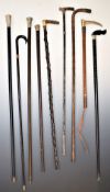 Eight vintage walking sticks including 9ct gold collared example, four with hallmarked silver