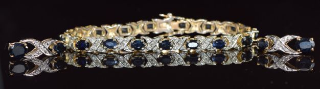 A silver gilt bracelet set with oval cut sapphires, with matching earrings