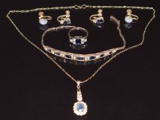 A suite of yellow metal jewellery set with blue and white sapphires comprising ring, bracelet,