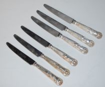 Seven pistol grip hallmarked silver handled knives comprising three 24.5cm and four 21.5cm,