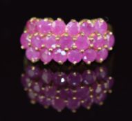A 9ct gold ring set with three rows of rubies, 3.5g, size J
