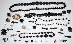 A collection of Victorian jet jewellery including carved bracelet and French jet beads, cameo