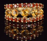 A 9ct gold ring set with citrines and garnets, 3.3g, size J