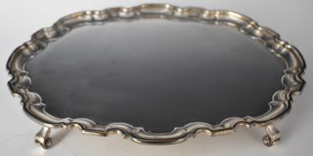 Elkington Elizabeth II hallmarked silver oval salver or tray with shaped edge, raised on four scroll