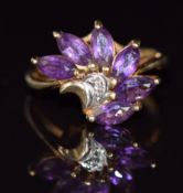 A 9ct gold ring set with a diamonds and marquise cut amethysts, 3.2g, size J/K