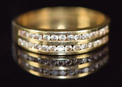 An 18ct gold ring set with two rows of diamonds, 2.9g, size J