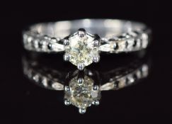 An 18ct white gold ring set with a diamond of approximately 0.3ct and black diamonds to the