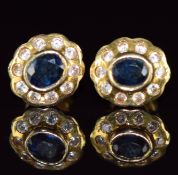 A pair of 14k gold earrings set with oval cut sapphires surrounded by diamonds, 3.1g