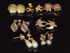 Six pairs of 9ct gold earrings including swallows, shells set with pearls, bows, etc (8.9g) and a
