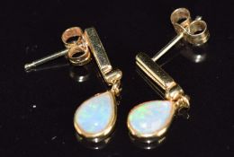A pair of 18ct gold earrings set with pear cut opal cabochons, 2.5g, 2cm