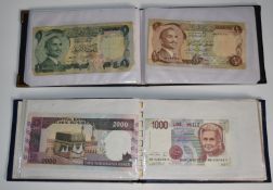 Two small albums of world banknotes to include 1975 Jordanian example